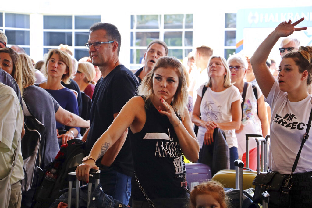 British passengers with Thomas Cook wait in queue at Antalya airport in Antalya, Turkey, Monday Sept. 23, 2019. Hundreds of thousands of travellers were stranded across the world Monday after British tour company Thomas Cook collapsed, immediately halting almost all its flights and hotel services and laying off all its employees. According to reports Monday morning some 21,000 Thomas Cook travellers were stranded in Turkey alone. Photo: IHA via AP