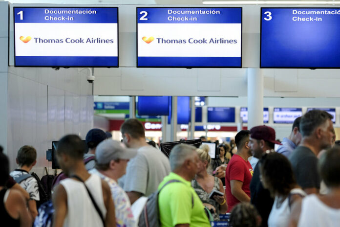 Stranded tourists line up in front of the Thomas Cook counter at the Cancun airport in Mexico, Monday, Sept. 23, 2019. British tour company Thomas Cook collapsed early Monday after failing to secure emergency funding, leaving tens of thousands of vacationers stranded abroad. Photo: Victor Ruiz / AP