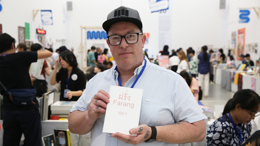 Nathan Larkin holding his latest publication “Farang Vol. 1” at Bangkok Art Book Fair on Sept. 5.