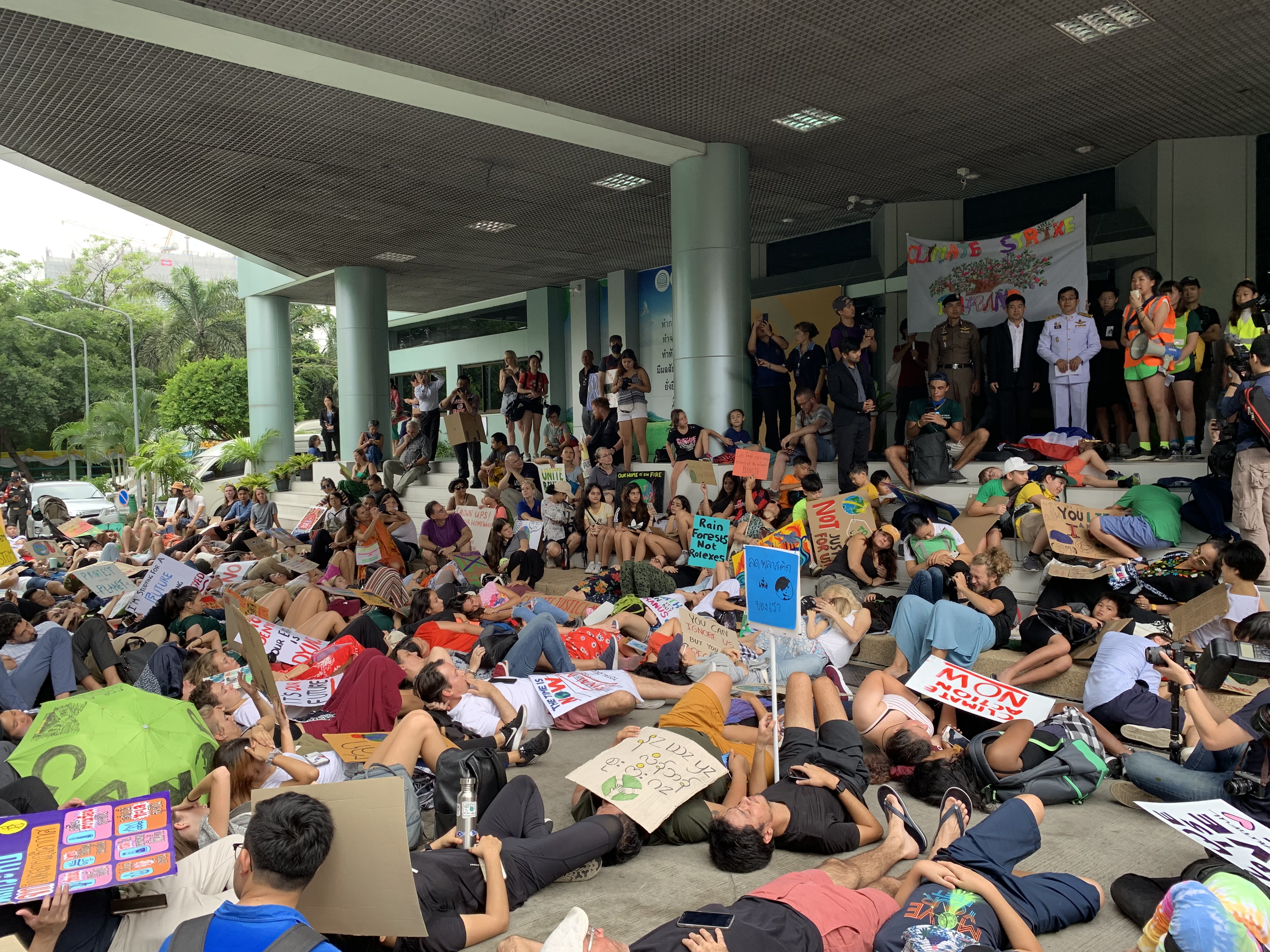 Protesters laying on the ground as a symbol for impacts of climate change.
