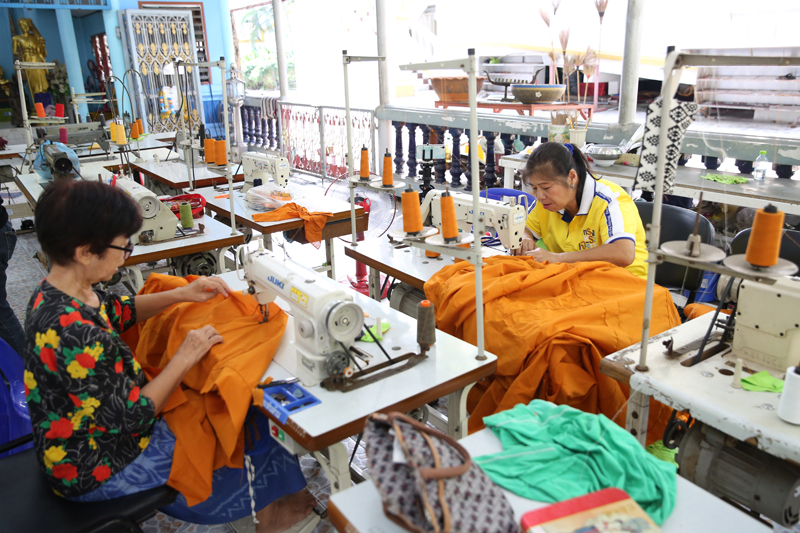 Volunteers sewing the robes.