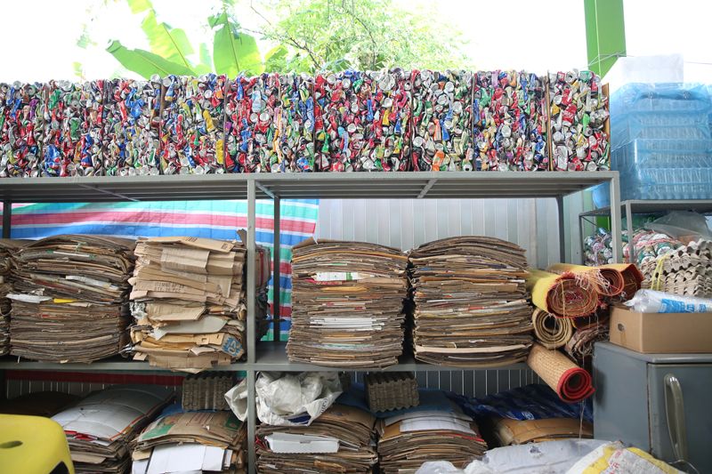 Aluminium cans and paper cartons being stored in the warehouse, awaiting to be sold or reused.