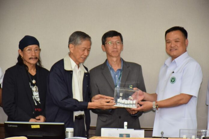 Thailand's Public Health Minister Anutin Chanvirakul, right, presents a batch of CBD oil to a hospital for medical use on Sep. 25, 2019.