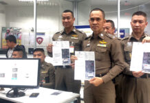 New 4K Traffic Cameras to Bust Bangkok’s Red Light Runners Police officers holding tickets at the Traffic Police Command Center on Aug. 30.