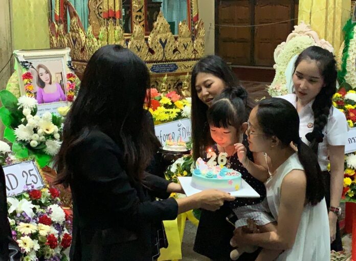 Thitima “Bell” Noraphanpiphat’s 3-year-old daughter blew birthday cake candles on what would have been Thitima’s 26th birthday in front of her coffin at a funeral in Bangkok, Sep. 19, 2019.