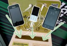 Dump Your Phone E-Waste at AIS Shops in Bangkok Old smartphones and headphones overlaid on top of a e-waste donation box taken on Sept. 5, 2019 at at Siam Paragon.