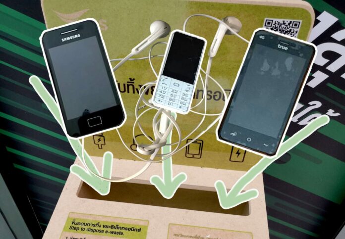 Old smartphones and headphones overlaid on top of a e-waste donation box taken on Sept. 5, 2019 at at Siam Paragon. Old smartphones and headphones overlaid on top of a e-waste donation box taken on Sept. 5, 2019 at at Siam Paragon.