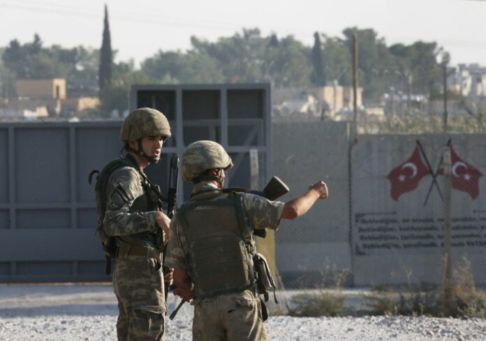 Shortly after the Turkish operation inside Syria had started, Turkish soldier stand at the border with Syria in Akcakale, Sanliurfa province, southeastern Turkey, Wednesday, Oct. 9, 2019. (AP Photo/Lefteris Pitarakis)
