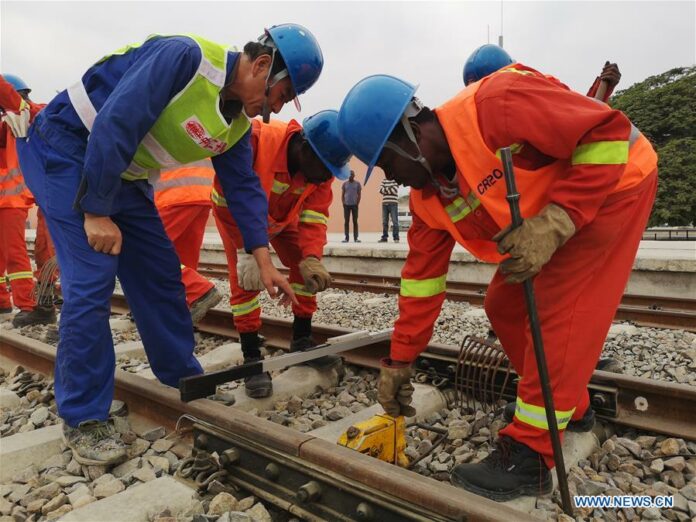Workers of China Railway 20th Bureau Group Corporation perform maintenance work for the Benguela Railway in Lobito, Angola, Aug. 2, 2019. (Photo by Liu Zhi/Xinhua)
