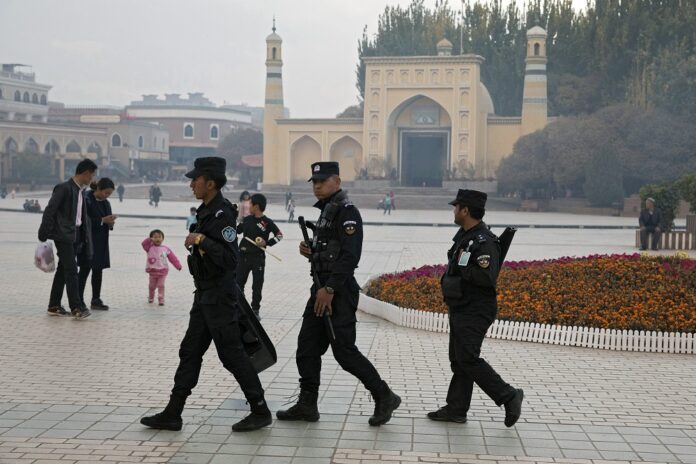 In this Nov. 4, 2017, file photo, Uighur security personnel patrol near the Id Kah Mosque in Kashgar in western China's Xinjiang region. (AP Photo/Ng Han Guan, File)