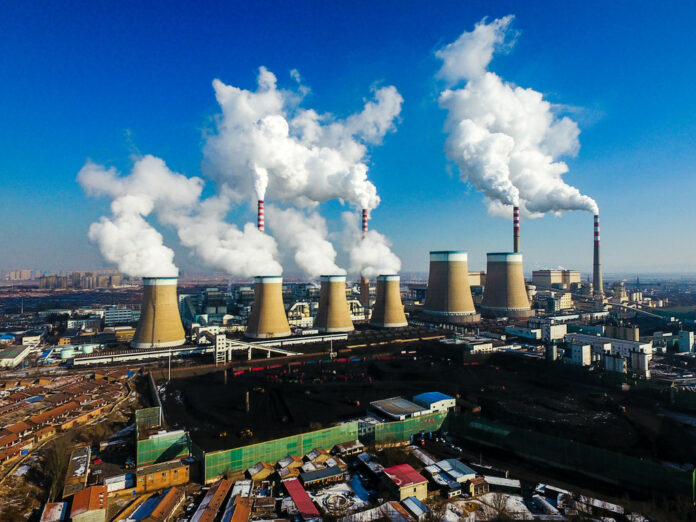 Smoke is discharged from chimneys at a coal-fired power plant of China Guodian Corporation in Datong city, north China's Shanxi province, March 17, 2018. Image: China Daily.