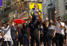 Hong Kong Leader Bans Masks in Hardening Stance on Protests Protesters wear masks and hold up their hands to represent their five demands in Hong Kong Friday, Oct. 4, 2019. Hong Kong pro-democracy protesters marched in the city center Friday ahead of plans by the city’s embattled leader to deploy emergency powers to ban people from wearing masks in a bid to quash four months of anti-government demonstrations. Photo: Vincent Yu / AP