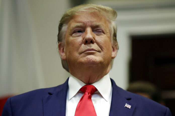 President Donald Trump winks as he listens before a trade agreement signing with Japan in the Roosevelt Room of the White House, Monday, Oct. 7, 2019, in Washington. Photo: Evan Vucci / AP