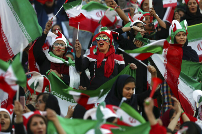 Iranian women cheer during a soccer match between their national team and Cambodia in the 2022 World Cup qualifier at the Azadi (Freedom) Stadium in Tehran, Iran, Thursday, Oct. 10, 2019. Photo: Vahid Salemi / AP
