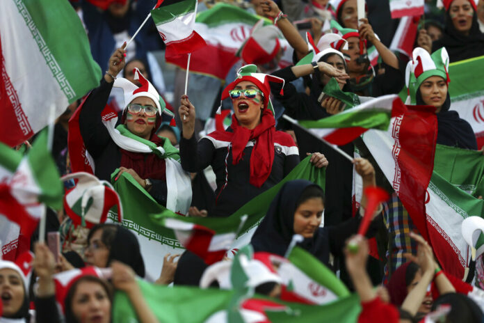 Iranian women cheer during a soccer match between their national team and Cambodia in the 2022 World Cup qualifier at the Azadi (Freedom) Stadium in Tehran, Iran, Thursday, Oct. 10, 2019. Photo: Vahid Salemi / AP Iranian women cheer during a soccer match between their national team and Cambodia in the 2022 World Cup qualifier at the Azadi (Freedom) Stadium in Tehran, Iran, Thursday, Oct. 10, 2019. Photo: Vahid Salemi / AP