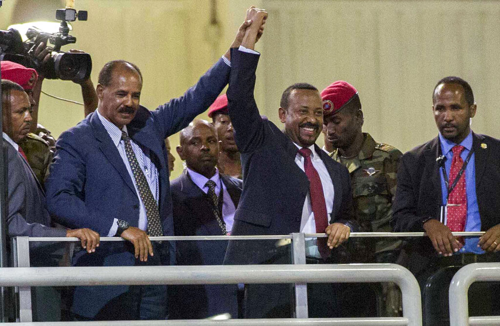 In this Sunday July 15, 2018 file photo, Eritrean President Isaias Afwerki, second left, and Ethiopia's Prime Minister Abiy Ahmed, center, hold hands as they wave at the crowds in Addis Ababa, Ethiopia. Once official rivals, the leaders of Ethiopia and Eritrea have embraced warmly to the roar of a crowd of thousands at a concert celebrating the end of a long state of war. The 2019 Nobel Peace Prize was given to Ethiopian Prime Minister Abiy Ahmed on Friday Oct. 11, 2019. Photo: Mulugeta Ayene / AP