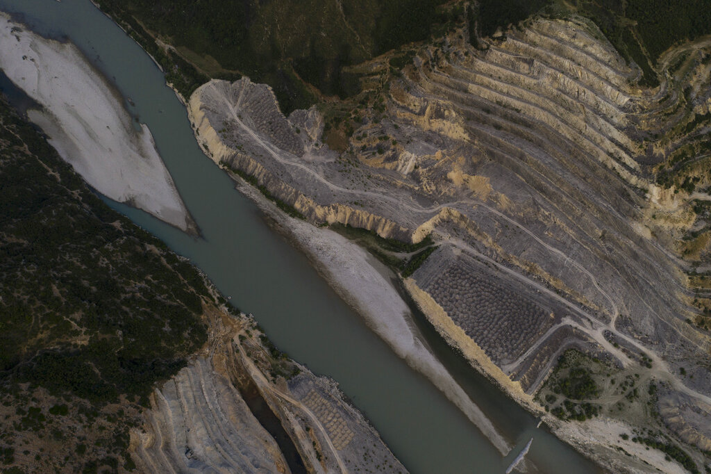 This June 23, 2019 aerial photo shows the construction site of the Kalivac dam on the banks of the Vjosa River in Albania. As pressure to build dams intensifies in less developed countries, the opposite is happening in the U.S. and western Europe, where there's a movement to tear down dams considered obsolete and environmentally destructive. Photo: Felipe Dana / AP
