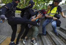 Hong Kong Descends Into Chaos Again as Protesters Defy Ban Protesters attack a man who was trying to stop them for vandalizing near the Tsim She Tsui police station during a rally in Hong Kong, Sunday, Oct. 20, 2019. Hong Kong protesters again flooded streets on Sunday, ignoring a police ban on the rally and demanding the government meet their demands for accountability and political rights. Photo: Vincent Yu / AP