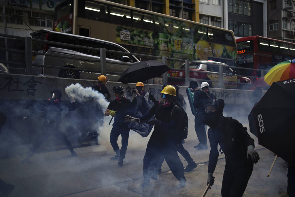 Protesters face police tear smoke in Hong Kong, Sunday, Oct. 20, 2019. Hong Kong protesters again flooded streets on Sunday, ignoring a police ban on the rally and demanding the government meet their demands for accountability and political rights. Photo: Felipe Dana / AP