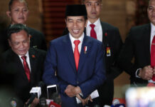 Widodo Begins 2nd Term Pledging to Make Indonesia Developed Indonesian President Joko Widodo, center, smiles as he speaks to the media upon arrival after his inauguration for his second term, at Merdeka Palace in Jakarta, Indonesia, Sunday, Oct. 20, 2019. Widodo, who rose from poverty and pledged to champion democracy, fight entrenched corruption and modernize the world's most populous Muslim-majority nation, was sworn in Sunday for his second and final five-year term with a pledge to take bolder actions. Photo: Dita Alangkara / AP