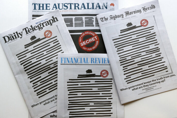 Newspapers display redacted copy on their front pages in Sydney, Monday, Oct. 21, 2019. Australia's major newspapers have published redacted front pages in a coordinated campaign to highlight government secrecy that is often justified on national security grounds. Photo: Rick Rycroft / AP