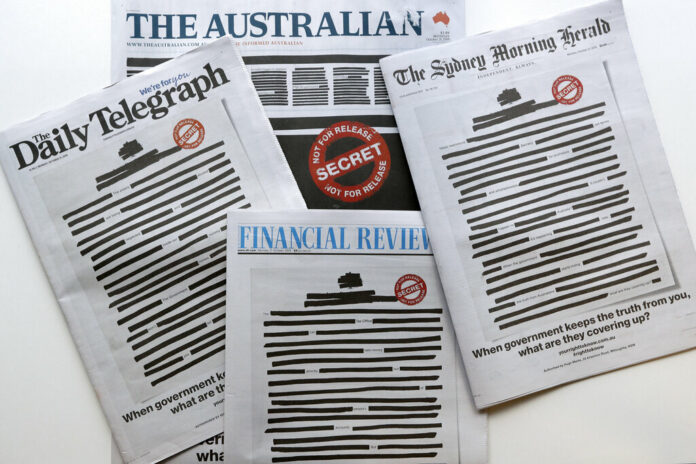 Newspapers display redacted copy on their front pages in Sydney, Monday, Oct. 21, 2019. Australia's major newspapers have published redacted front pages in a coordinated campaign to highlight government secrecy that is often justified on national security grounds. Photo: Rick Rycroft / AP Newspapers display redacted copy on their front pages in Sydney, Monday, Oct. 21, 2019. Australia's major newspapers have published redacted front pages in a coordinated campaign to highlight government secrecy that is often justified on national security grounds. Photo: Rick Rycroft / AP