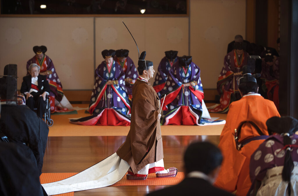 Japan's Emperor Naruhito, center, leaves at the end of the enthronement ceremony where he officially proclaimed his ascension to the Chrysanthemum Throne at the Imperial Palace in Tokyo, Tuesday, Oct. 22, 2019. Photo: Kazuhiro Nogi / Pool Photo via AP