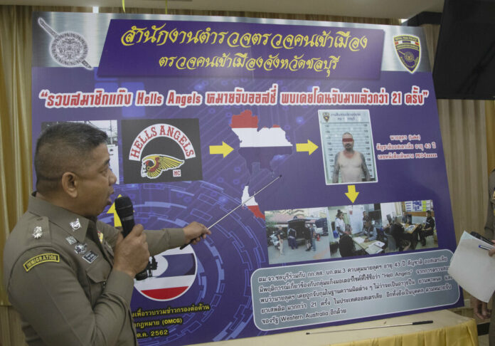 An immigration officer uses a timeline information board describing details of Australian national Luke Anderson during a press conference at the Immigration Bureau in Bangkok, Thailand, Monday, Oct. 28, 2019. Police have arrested suspected Australian Hell's Angels gang member Luke Anderson last Thursday following a meeting with embassy officials over the problem of outlaw motorbike Hell's Angels gang member gangs. They have revoked his visa and say they will deport him, shortly. Photo: Sakchai Lalit / AP