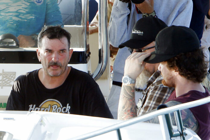 British national Phil Bambridge, left, father of missing backpacker Amelia Bambridge, sits on a speedboat as he talks with his family members as they continue the search on Koh Rong island off southwestern Cambodia, Wednesday, Oct. 30, 2019. Around 150 people are taking part in the search for Bambridge who has not been seen since last Wednesday night when she attended a beach party on Koh Rong island in southwestern Cambodia joined by tourists of various nationalities. Photo: Heng Sinith / AP