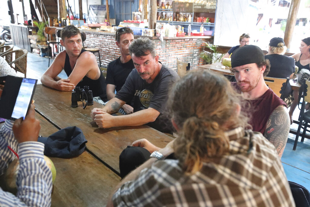 British national Phil Bambridge, center, the father of missing backpacker Amelia Bambridge, sits with his family during a meeting with the governor of Koh Rong City Noun Bunthol, unseen, after a day of searching off Koh Rong island in southwestern Cambodia, Wednesday, Oct. 30, 2019. Photo: Heng Sinith / AP