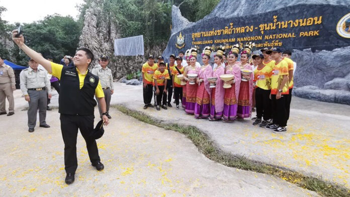 Varawut Silpa-archa taking a selfie with Wild Boars footballers and a group of dancers during the opening ceremony of the park’s sign on Oct. 10, 2019.