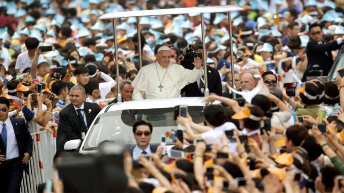 Pope Francis is greeted by the faithful upon his arrival for a beatification Mass in Seoul, South Korea, on Aug. 16, 2014. Photo: Associated Press