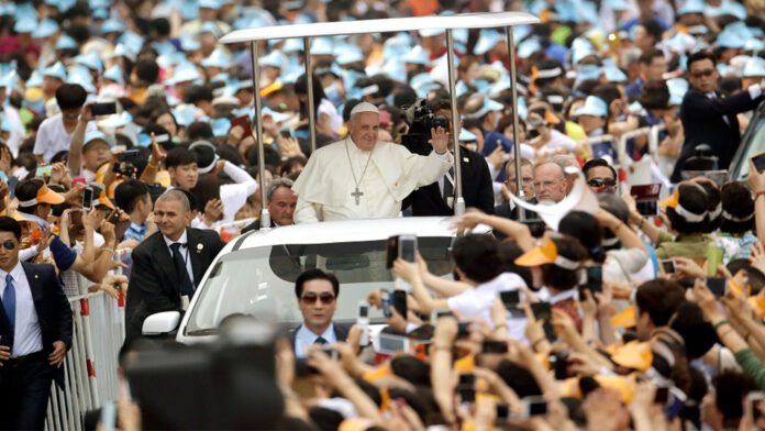 Pope Francis is greeted by the faithful upon his arrival for a beatification Mass in Seoul, South Korea, on Aug. 16, 2014. Photo: Associated Press Pope Francis is greeted by the faithful upon his arrival for a beatification Mass in Seoul, South Korea, on Aug. 16, 2014. Photo: Associated Press