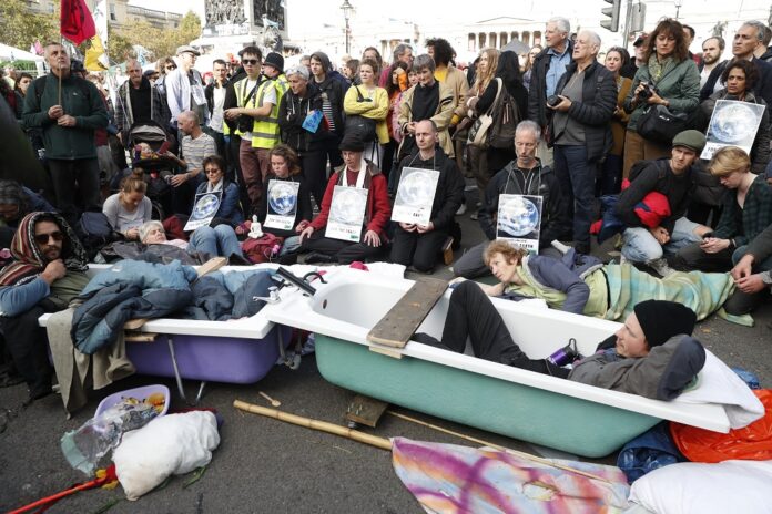 Climate change protesters lie in to joined bathtubs as the demonstrate in Trafalgar Square in London, Thursday, Oct. 10, 2019. Image: AP