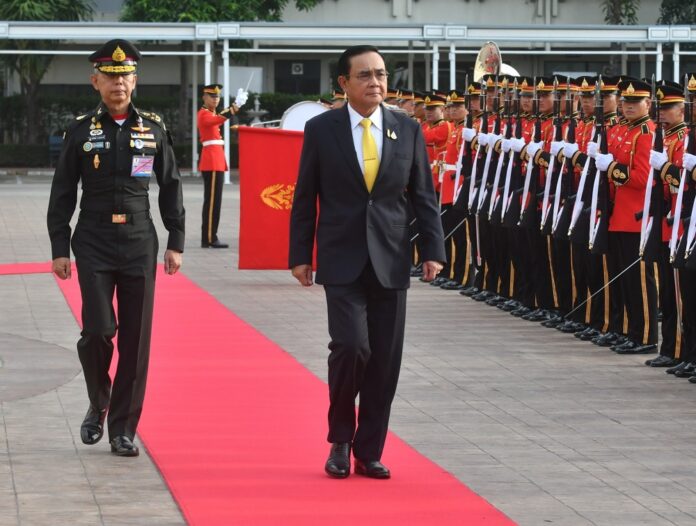 PM Prayuth Chan-ocha and army chief Gen. Apirat Kongsompong, who also serve as director and deputy of ISOC, respectively, inspect the guard of honor of the army HQ on Oct. 9, 2019.
