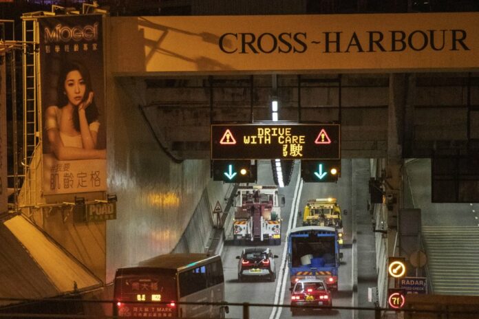 Vehicles move through the Cross-Harbor Tunnel, which has reopened, in Hong Kong on Wednesday, Nov. 27, 2019. The major tunnel has reopened in Hong Kong after a two-week closure because of anti-government protests. (AP Photo/Ng Han Guan)