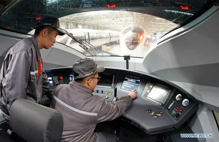 Workers build a bullet train at a factory of CRRC Tangshan Co., Ltd. in Tangshan, north China's Hebei Province, March 23, 2018. (Xinhua/Yang Shiyao)
