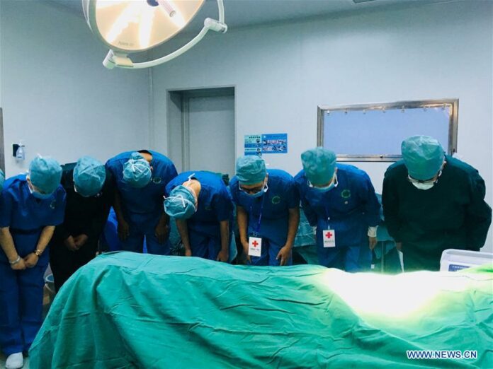 Medical staff bow to the organ donor Li Hongyan before the organ procurement surgery in Shannan, southwest China's Tibet Autonomous Region, Aug. 22, 2018. His organs were donated to four recipients. (Xinhua/Wang Qinou)