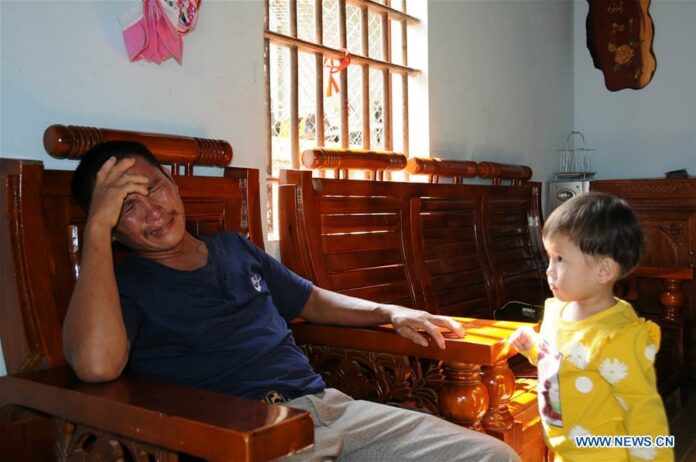 Cao Huy Thanh's elder brother (L) grieves as his daughter looks on in Vietnam's central Nghe An province, Nov. 8, 2019. Thanh, who was among the 39 Vietnamese nationals found dead in a lorry in Essex, Britain, was the breadwinner of a family with four children. Photo: Tao Jun / Xinhua