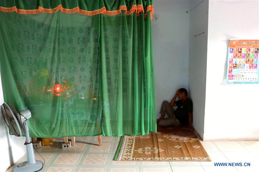 Cao Huy Thanh's elder brother grieves in front of Thanh's altar in Vietnam's central Nghe An province, Nov. 8, 2019. Photo: Wang Di / Xinhua