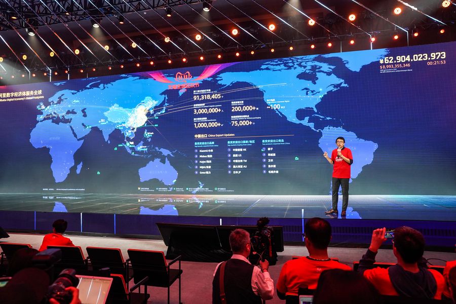 A staff of the Alibaba Group speaks in front of a giant screen showing the real-time sales data of Tmall on Singles' Day at the media center in Alibaba Group's Xixi Park, in Hangzhou, Zhejiang Province, Nov. 11, 2019. Photo: Yin Xiaosheng / Xinhua