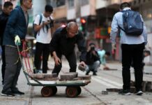 Hong Kong Residents Clear Barricades, Mourn Riot Victim