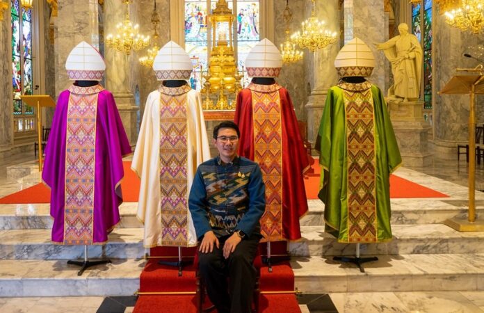 Thai designer Athiwat Chuenwut poses for photos with the four holy vestments he designed for Pope Francis. Image: Athiwat Chuenwut / Facebook