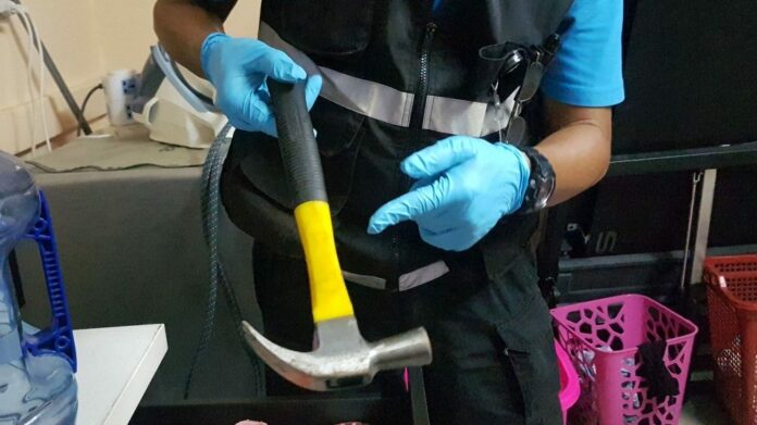 Police show a hammer they believe to be the murder weapon.