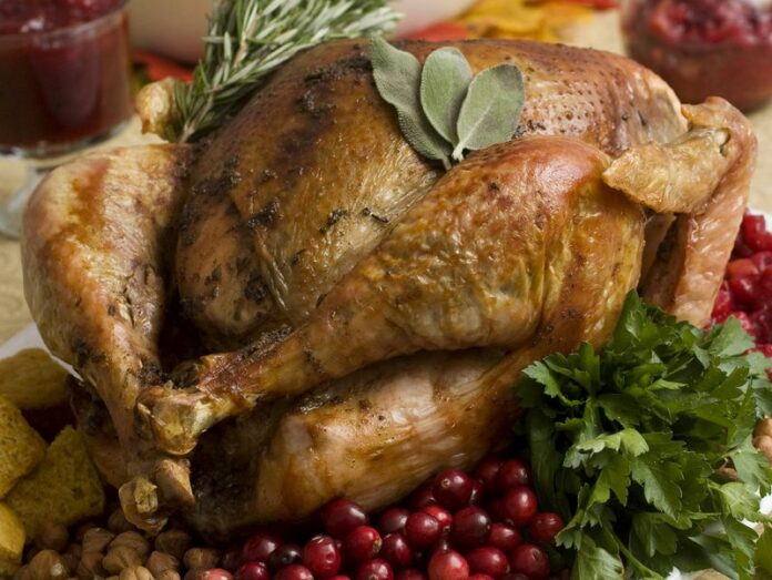 This Nov. 2, 2009, file photo shows a Thanksgiving turkey in Concord, N.H. Food safety experts say raw turkeys shouldn’t be rinsed, since that can spread harmful bacteria. Cooking should kill any germs. But bacteria can still spread in other ways, so washing and sanitizing hands and surfaces is still important. (AP Photo/Larry Crowe, File)