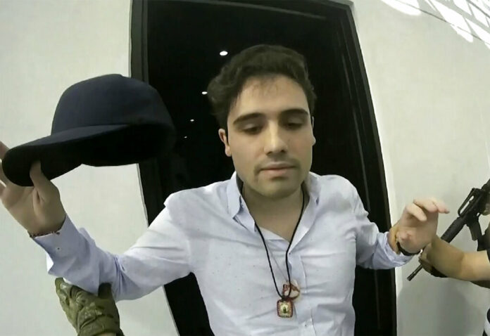 This Oct. 17, 2019 frame grab from video provided by the Mexican government shows Ovidio Guzman Lopez at the moment of his detention, in Culiacan, Mexico. Mexican security forces had Ovidio Guzman Lopez, a son of Joaquin This Oct. 17, 2019 frame grab from video provided by the Mexican government shows Ovidio Guzman Lopez at the moment of his detention, in Culiacan, Mexico. Mexican security forces had Ovidio Guzman Lopez, a son of Joaquin