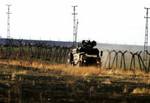Turkey Starts Returning IS Fighters; Deports US National In this photo taken from the outskirts of the village of Alakamis, in Idil province, southeastern Turkey, a Turkish army vehicles is driven in Turkey after conducting a joint patrol with Russian forces in Syria, Friday, Nov. 8, 2019. The Britain-based Syrian Observatory for Human Rights says a protester has been killed when he was run over in the village of Sarmasakh, Syria near the border by a Turkish vehicle during a joint patrol with Russia.The man was among residents who pelted with shoes and stones Turkish and Russian troops who were conducting their third joint patrol in northeastern Syria, under a cease-fire deal brokered by Moscow that forced Kurdish fighters to withdraw from areas bordering Turkey. Photo: Mehmet Guzel / AP
