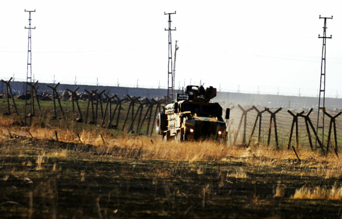 In this photo taken from the outskirts of the village of Alakamis, in Idil province, southeastern Turkey, a Turkish army vehicles is driven in Turkey after conducting a joint patrol with Russian forces in Syria, Friday, Nov. 8, 2019. The Britain-based Syrian Observatory for Human Rights says a protester has been killed when he was run over in the village of Sarmasakh, Syria near the border by a Turkish vehicle during a joint patrol with Russia.The man was among residents who pelted with shoes and stones Turkish and Russian troops who were conducting their third joint patrol in northeastern Syria, under a cease-fire deal brokered by Moscow that forced Kurdish fighters to withdraw from areas bordering Turkey. Photo: Mehmet Guzel / AP In this photo taken from the outskirts of the village of Alakamis, in Idil province, southeastern Turkey, a Turkish army vehicles is driven in Turkey after conducting a joint patrol with Russian forces in Syria, Friday, Nov. 8, 2019. The Britain-based Syrian Observatory for Human Rights says a protester has been killed when he was run over in the village of Sarmasakh, Syria near the border by a Turkish vehicle during a joint patrol with Russia.The man was among residents who pelted with shoes and stones Turkish and Russian troops who were conducting their third joint patrol in northeastern Syria, under a cease-fire deal brokered by Moscow that forced Kurdish fighters to withdraw from areas bordering Turkey. Photo: Mehmet Guzel / AP