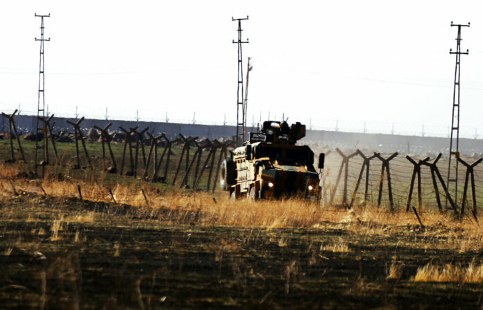 In this photo taken from the outskirts of the village of Alakamis, in Idil province, southeastern Turkey, a Turkish army vehicles is driven in Turkey after conducting a joint patrol with Russian forces in Syria, Friday, Nov. 8, 2019. The Britain-based Syrian Observatory for Human Rights says a protester has been killed when he was run over in the village of Sarmasakh, Syria near the border by a Turkish vehicle during a joint patrol with Russia.The man was among residents who pelted with shoes and stones Turkish and Russian troops who were conducting their third joint patrol in northeastern Syria, under a cease-fire deal brokered by Moscow that forced Kurdish fighters to withdraw from areas bordering Turkey. Photo: Mehmet Guzel / AP