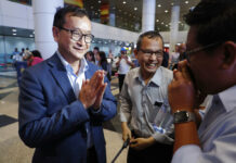 Cambodia’s Exiled Opposition Leader Makes It Part Way Home Cambodia's exiled opposition leader Sam Rainsy, left, greets supporters as he arrived at Kuala Lumpur International's Airport in Sepang, Malaysia Saturday, Nov. 9, 2019. Sam Rainsy landed in Kuala Lumpur in a bid to return to his homeland after Thailand had earlier blocked him from entering. Photo: Vincent Thian / AP